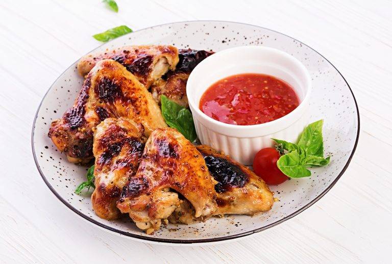 baked-chicken-wings-asian-style-tomatoes-sauce-plate-min